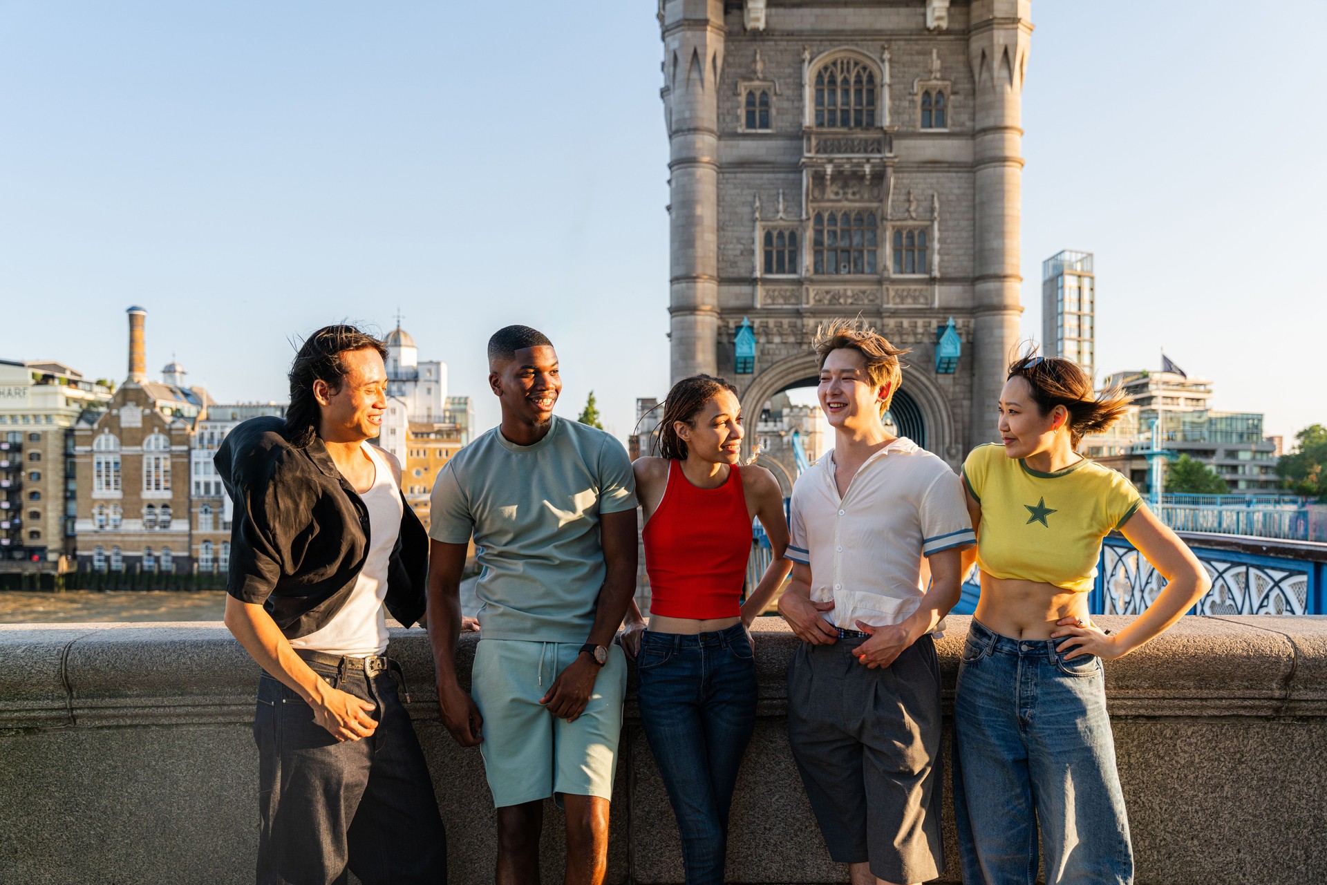 Multiracial group of happy young friends bonding in London