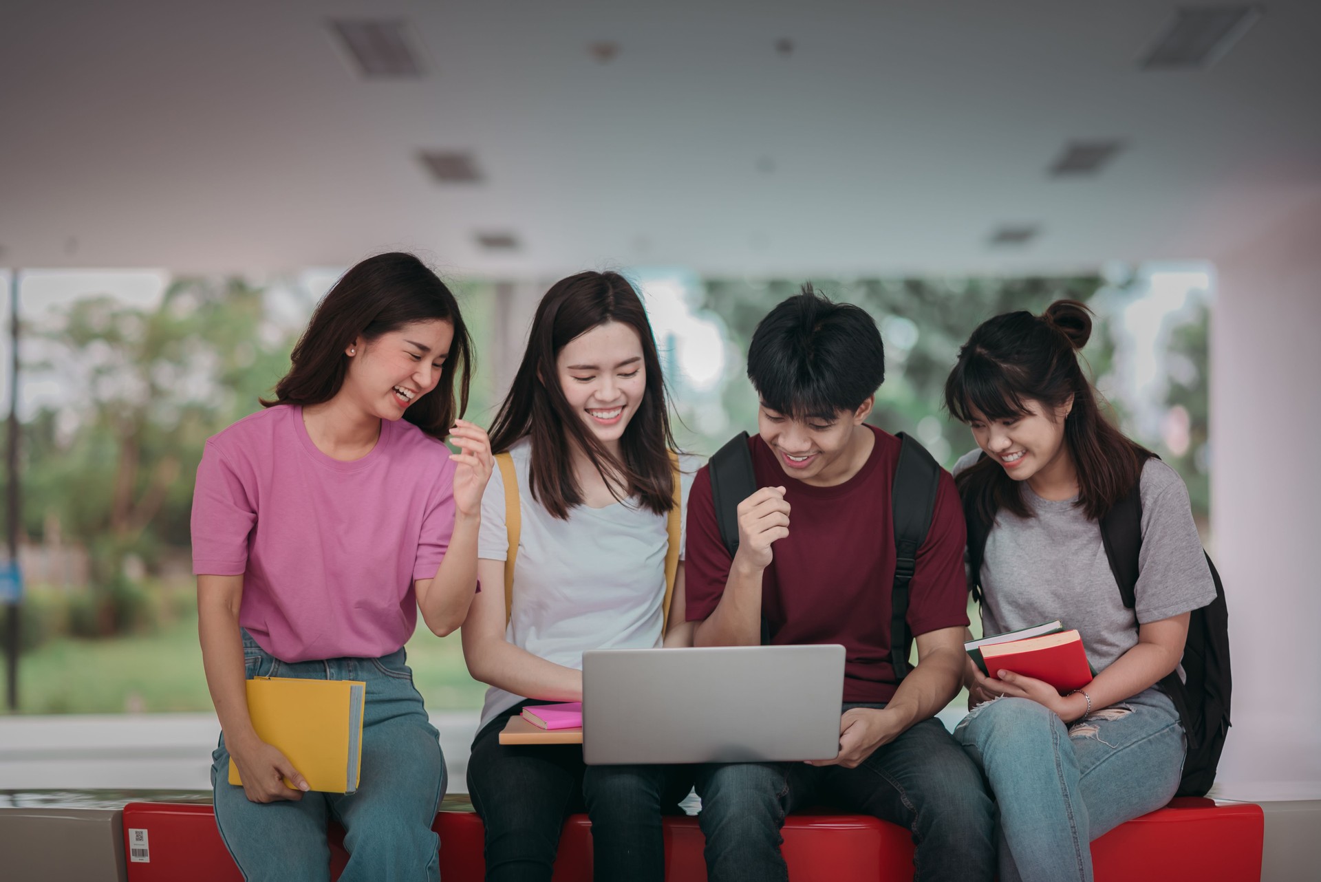 Asian group of student using laptop, digital tablet together. Lifestyle with information technology gadget education or social network concept.